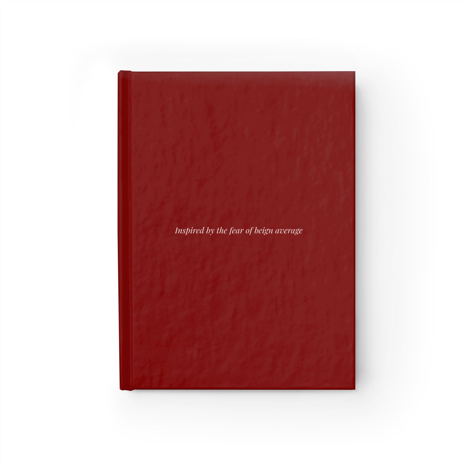 Burgundy hardcover journal with text inspired by the fear of being average