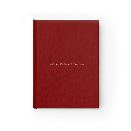 Burgundy hardcover journal with text inspired by the fear of being average